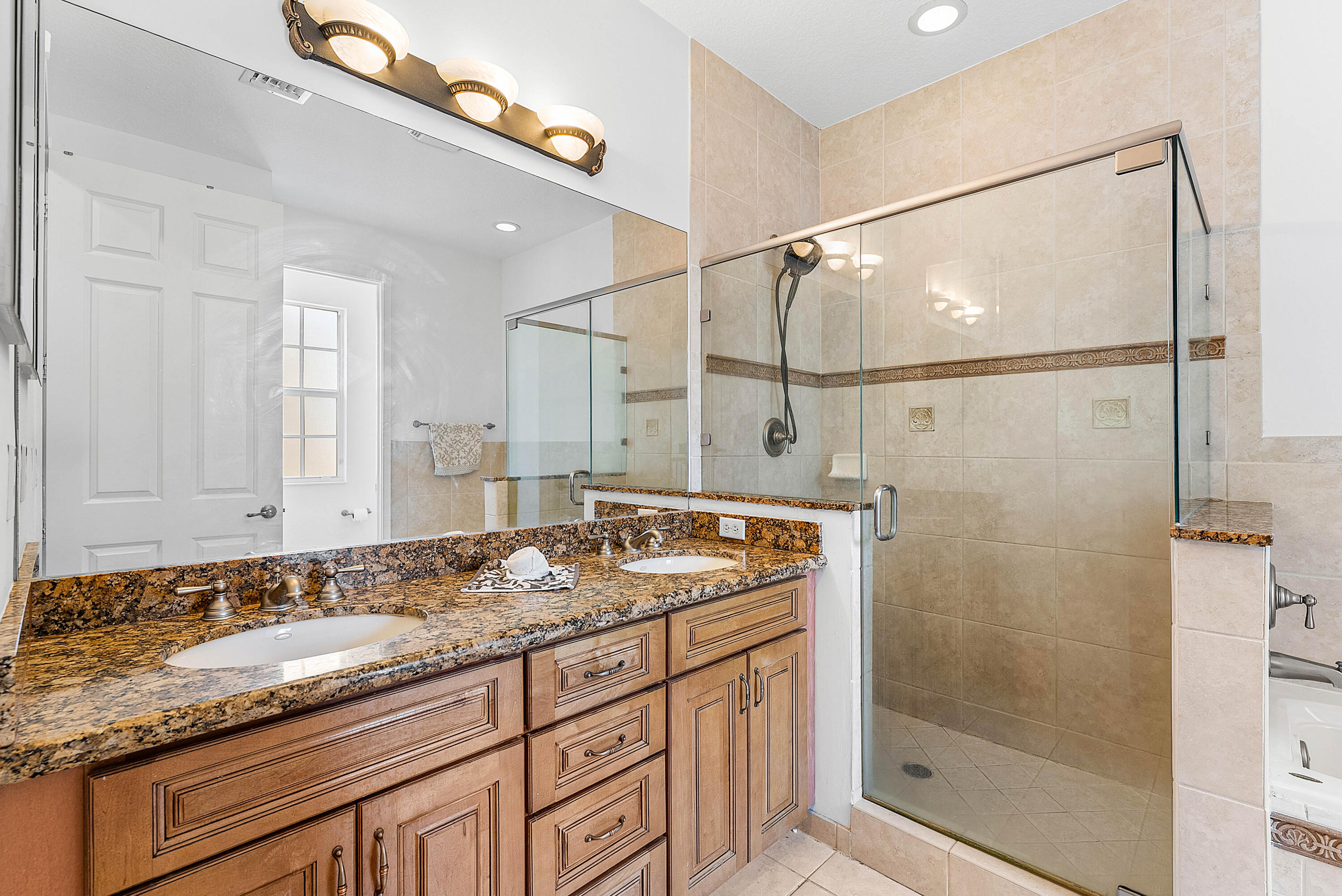 8309 Northwest 8th Way Boca Raton, FL 33487 - Photo 18 of 39 a bathroom with a granite countertop sink a mirror and shower