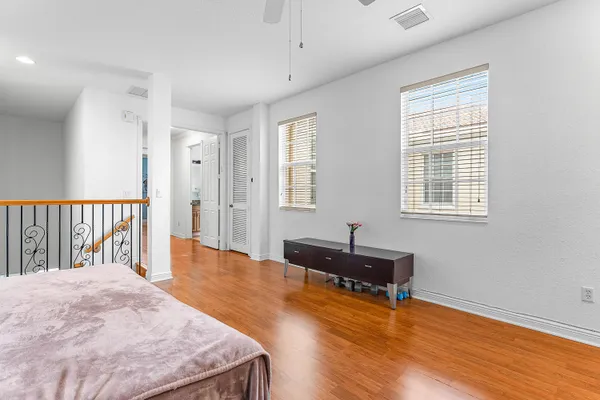 a spacious bedroom with a bed and a window