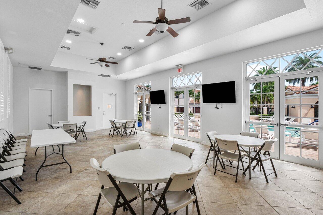 8309 Northwest 8th Way Boca Raton, FL 33487 - Photo 34 of 39 a view of a dining room with furniture wooden floor and chandelier