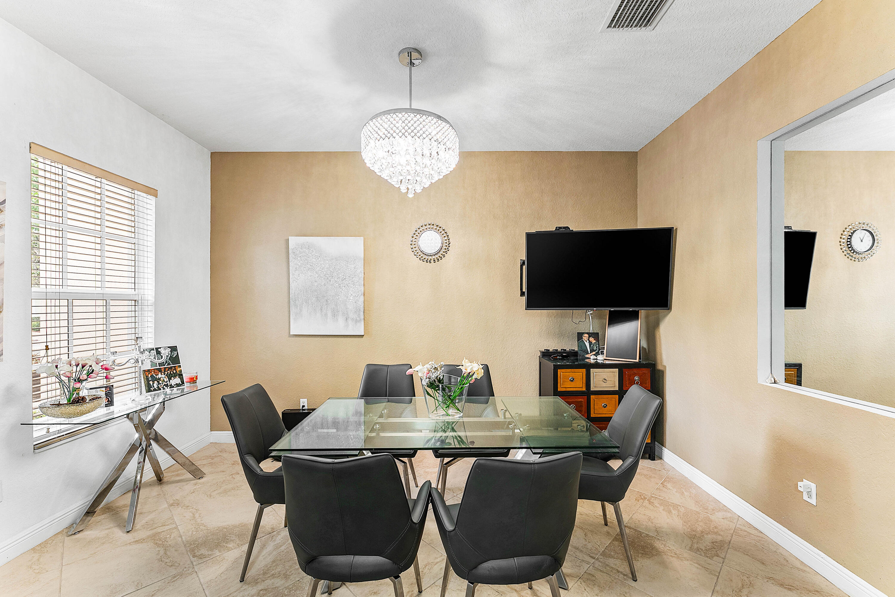 8309 Northwest 8th Way Boca Raton, FL 33487 - Photo 5 of 39 a view of a dining room with furniture wooden floor and chandelier