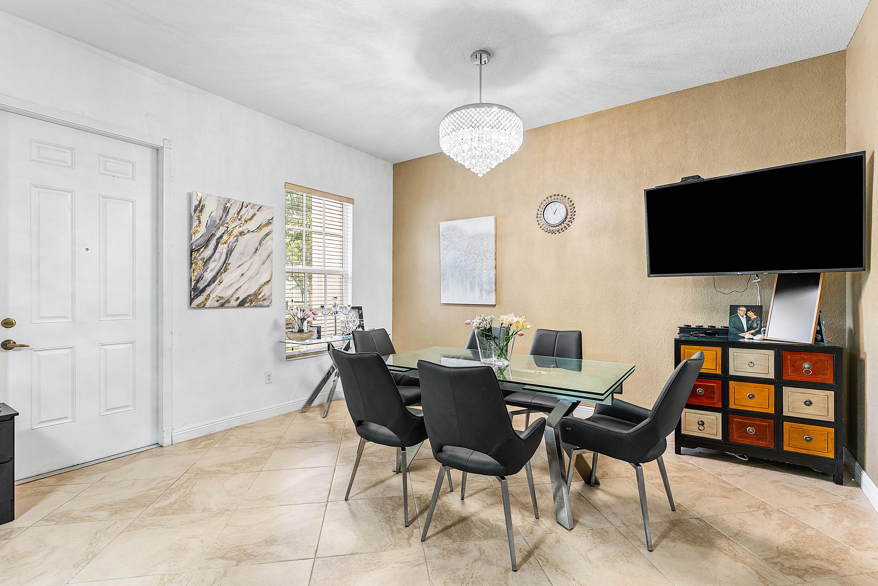 8309 Northwest 8th Way Boca Raton, FL 33487 - Photo 6 of 39 a view of a dining room with furniture and a flat screen tv