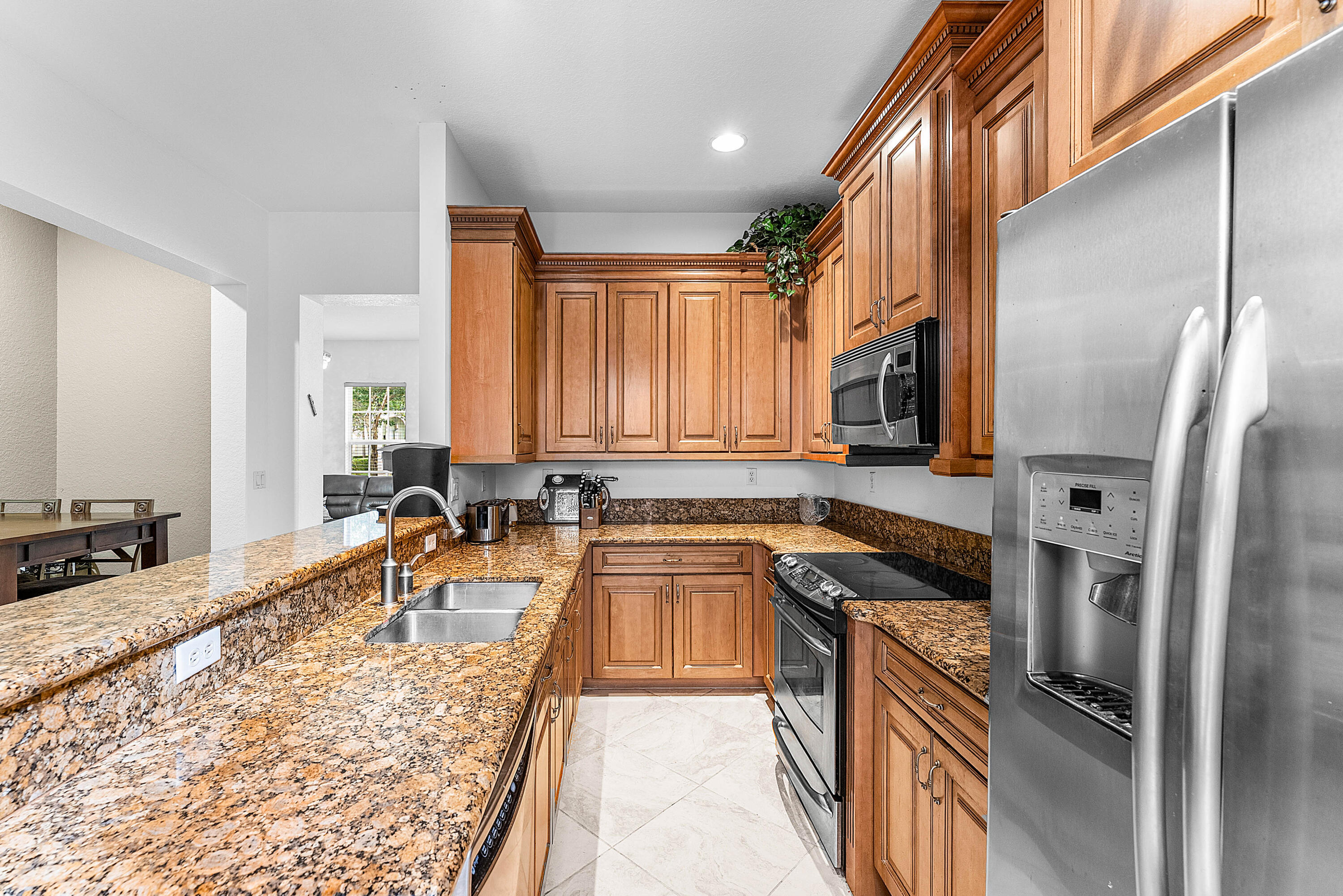 8309 Northwest 8th Way Boca Raton, FL 33487 - Photo 10 of 39 a kitchen with granite countertop a sink a counter top space stainless steel appliances and cabinets