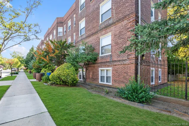 a view of a brick building next to a yard