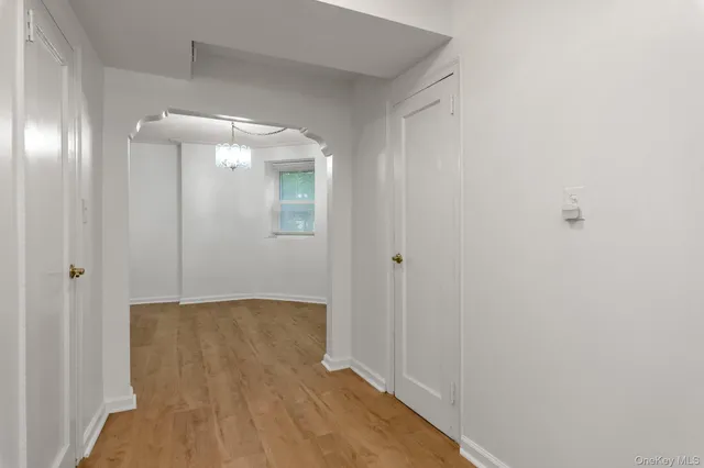 a view of hallway with wooden floor