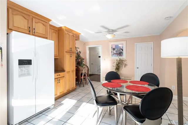 a view of a dining room with furniture a rug and wooden floor