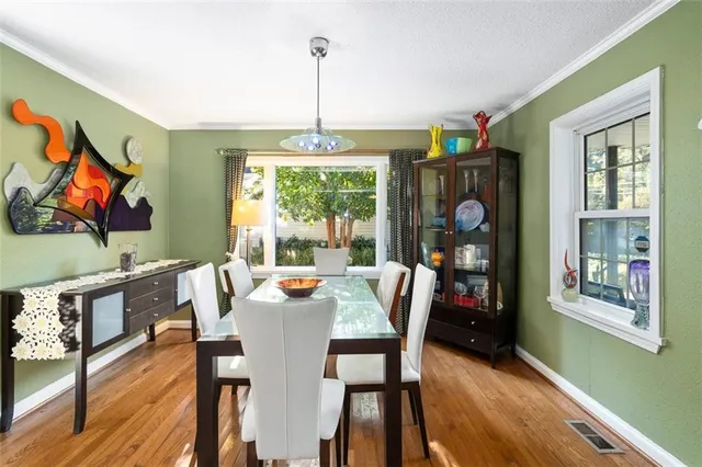a view of a dining room with furniture window and wooden floor