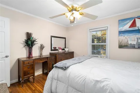 a bedroom with a bed table closet with potted plants