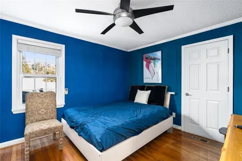 a bedroom with a large bed and a chandelier