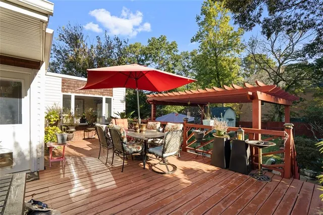 a view of a patio with table and chairs under an umbrella