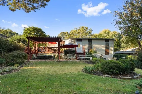 a view of a house with a yard porch and sitting area
