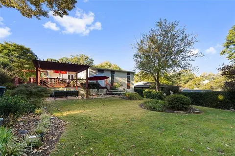 a view of a swimming pool and fire pit in the back yard