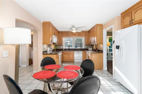a kitchen with stainless steel appliances dining table and chairs