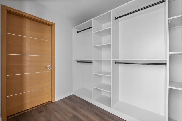 a view of a room with wooden floor