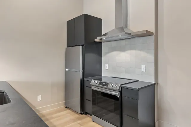 a kitchen with granite countertop a refrigerator and a stove