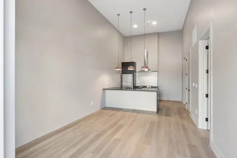 a view of a kitchen with a sink and a refrigerator
