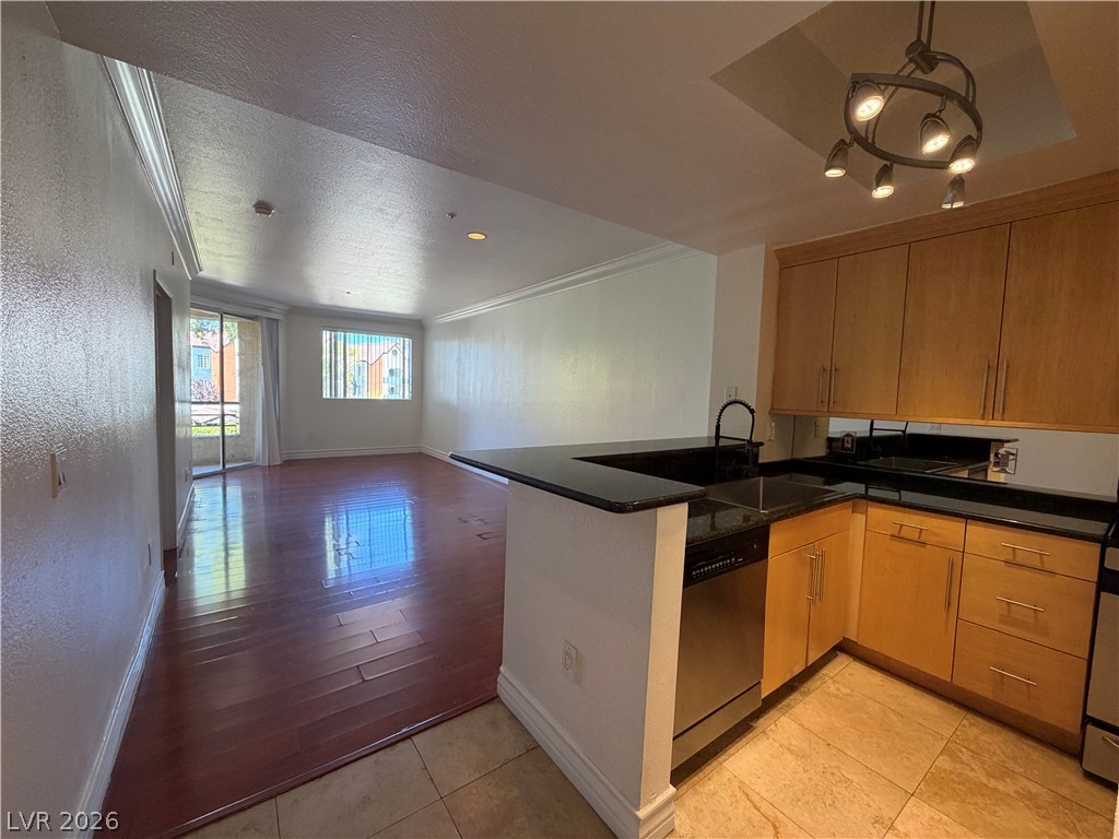 210 East Flamingo Road, Unit 126 Las Vegas, NV 89169 - Photo 3 of 16 An open-concept living space integrates a well-appointed kitchen with rich hardwood flooring throughout.