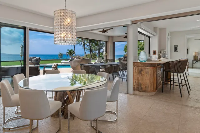 a living room with furniture kitchen view and a large window