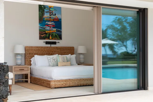 a bathroom with a granite countertop sink a large mirror and a bathtub
