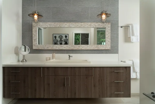 a bathroom with a glass shower door and a sink