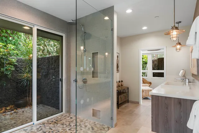 a bathroom with a tub a sink double vanity