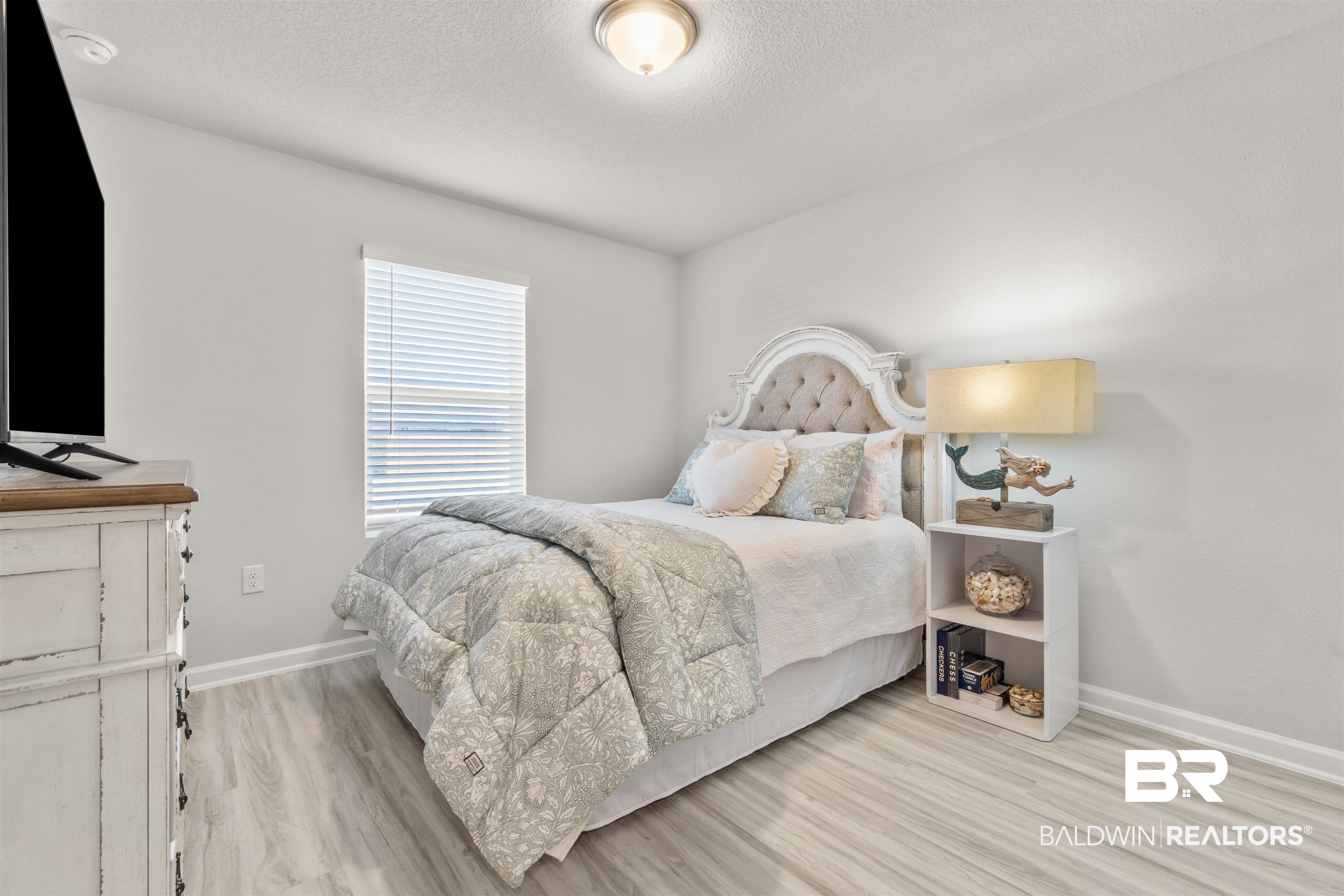 24472 Ringneck Loop Elberta, AL 36530 - Photo 31 of 46 Bedroom with wood-type flooring and a textured ceiling