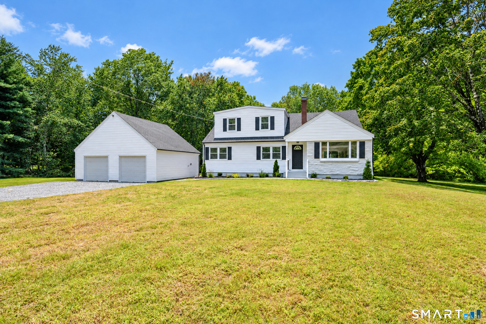 34 Rimmon Road Woodbridge, CT 06525 - Photo 2 of 40 Fresh, inviting exterior surrounded by mature trees and open lawn.