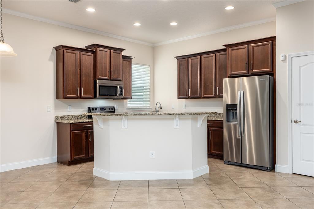 8216 Northwest 54th Street Gainesville, FL 32653 - Photo 27 of 58 a kitchen with stainless steel appliances granite countertop a refrigerator stove a sink and dishwasher