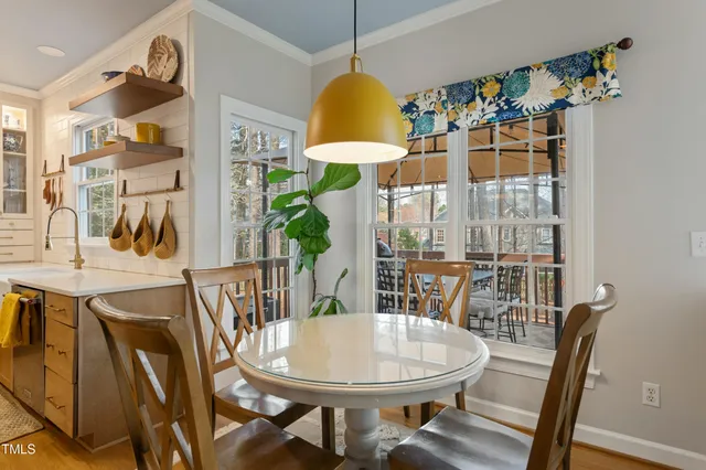 a view of a dining room with furniture one side kitchen view