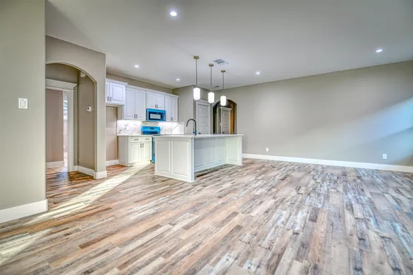 a view of a kitchen with a stove cabinets and a wooden floor