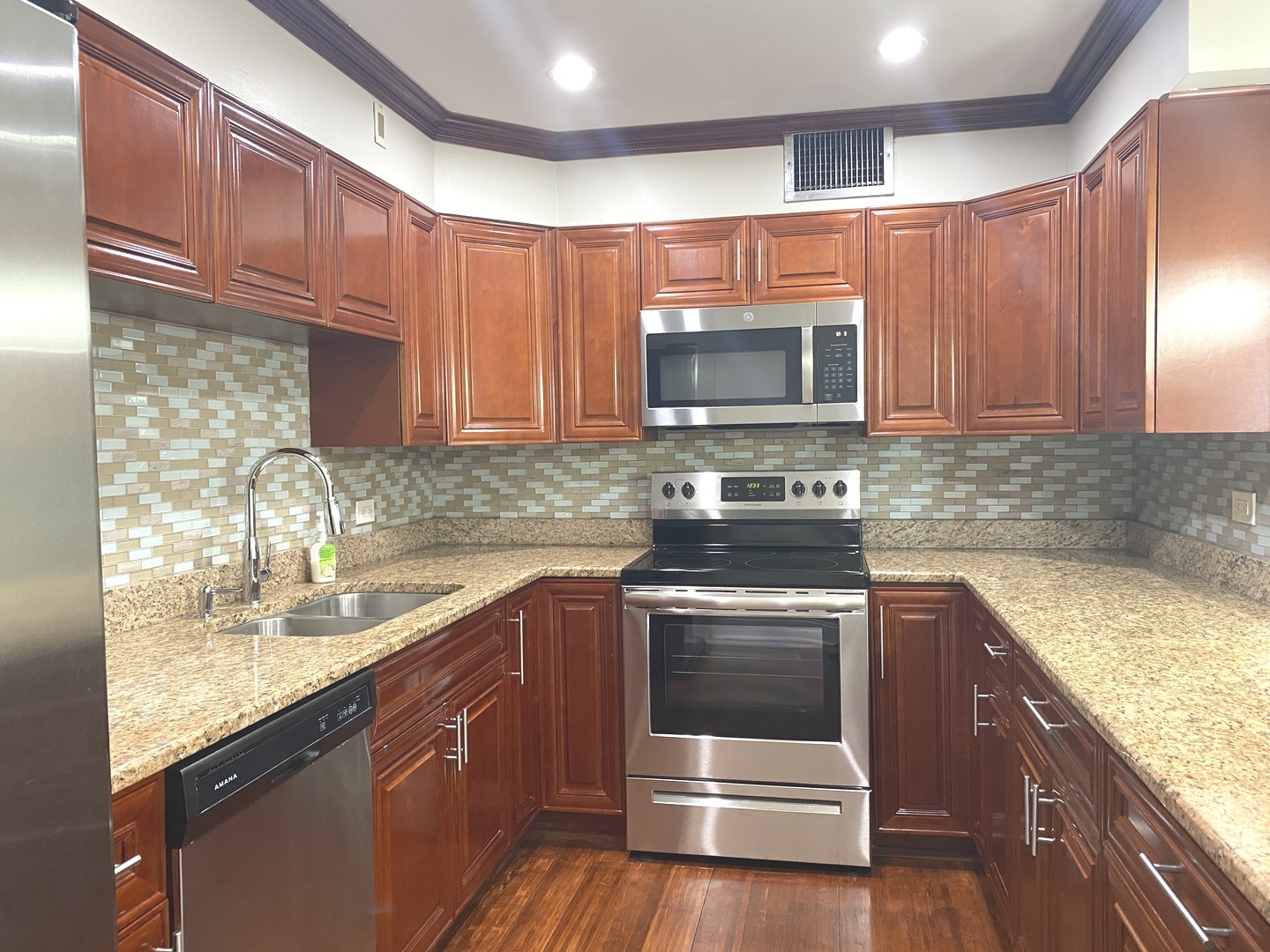 1567 Ridge Avenue, Unit 803 Evanston, IL 60201 - Photo 5 of 9 a kitchen with granite countertop a sink stove and microwave