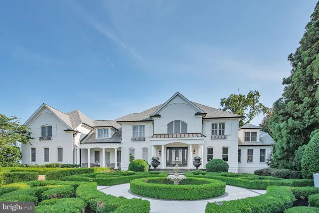 a front view of a residential houses with yard and green space