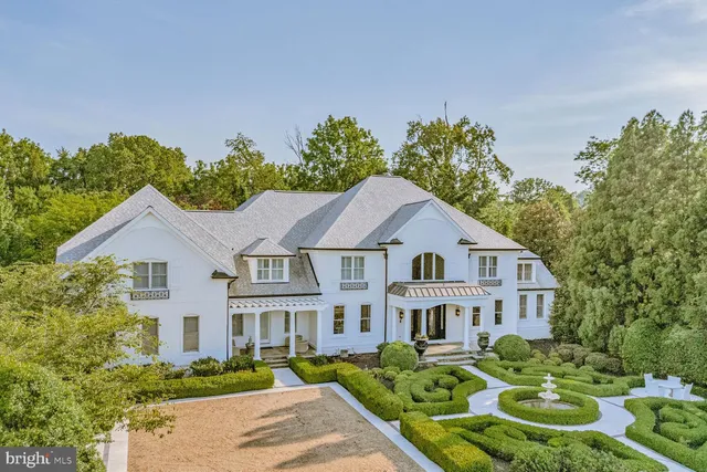 a living room with furniture or chandelier and a wooden floor