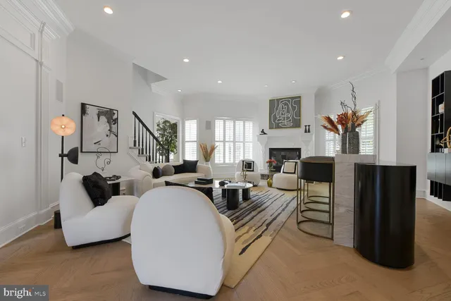 a view of a dining room with furniture a fireplace and a flat screen tv