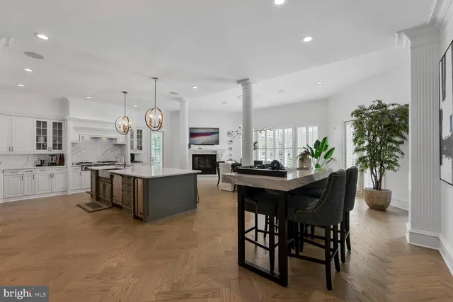 a living room with furniture a chandelier and a flat screen tv