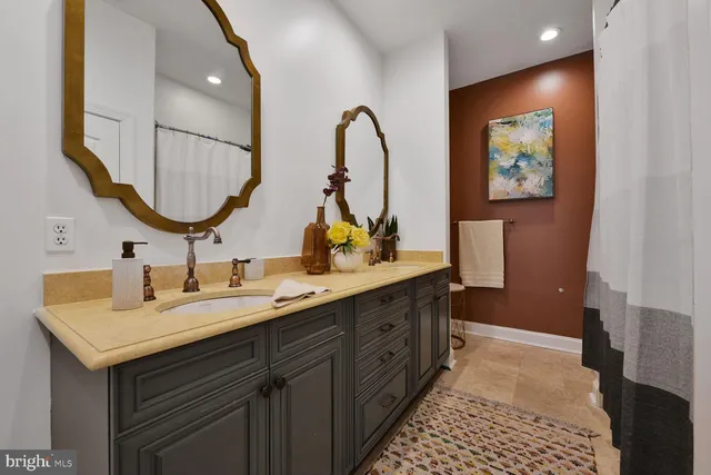 a front view of a house with a yard and tree