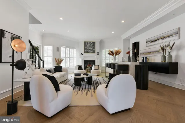a front view of a house with a yard and potted plants