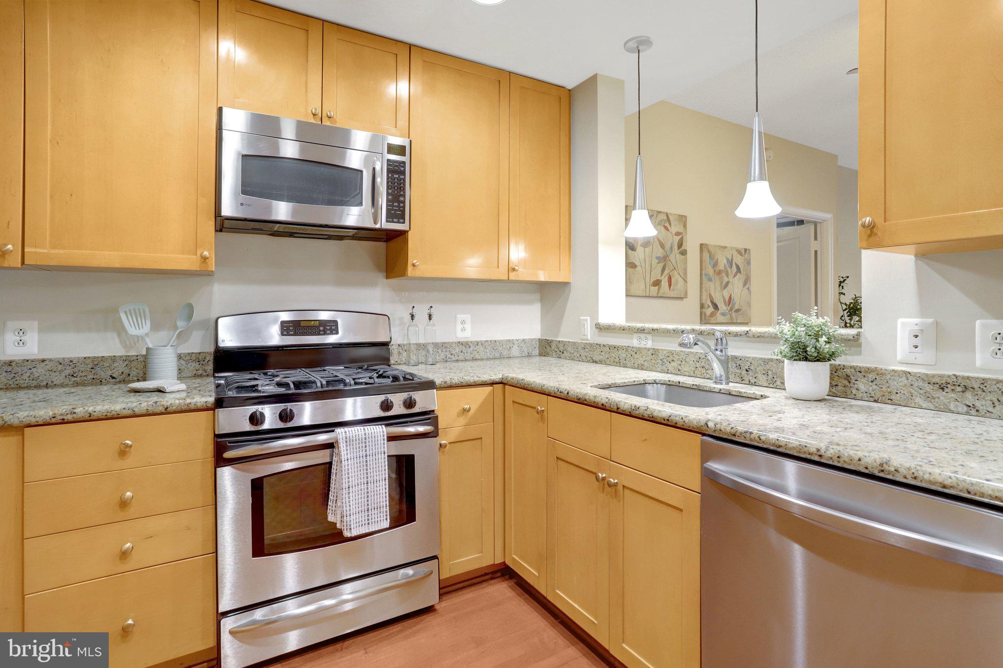 3650 South Glebe Road, Unit 442 Arlington, VA 22202 - Photo 16 of 54 a kitchen with stainless steel appliances granite countertop a sink a stove and oven with wooden floor