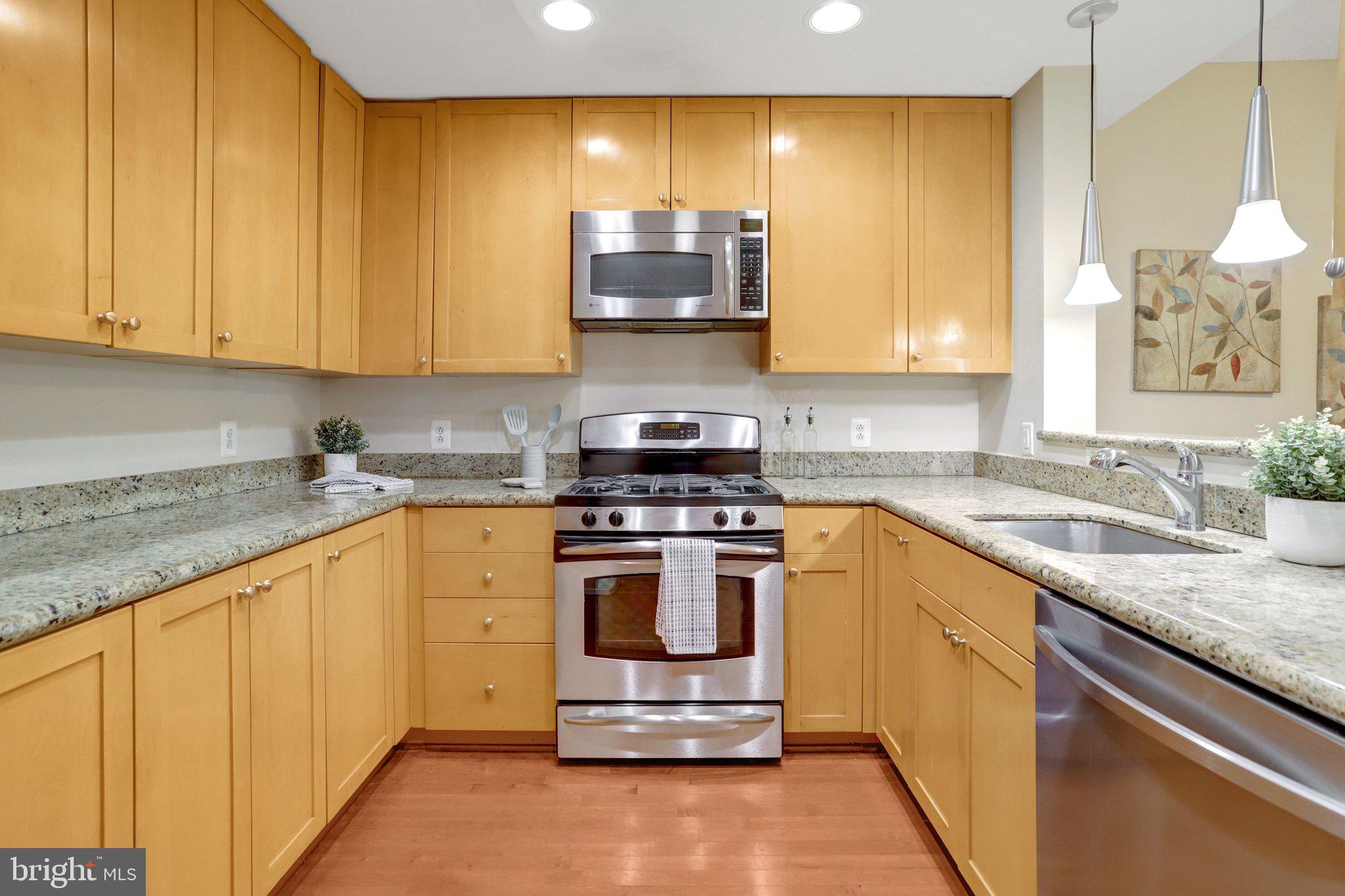 3650 South Glebe Road, Unit 442 Arlington, VA 22202 - Photo 17 of 54 a kitchen with stainless steel appliances granite countertop a stove a sink and a microwave