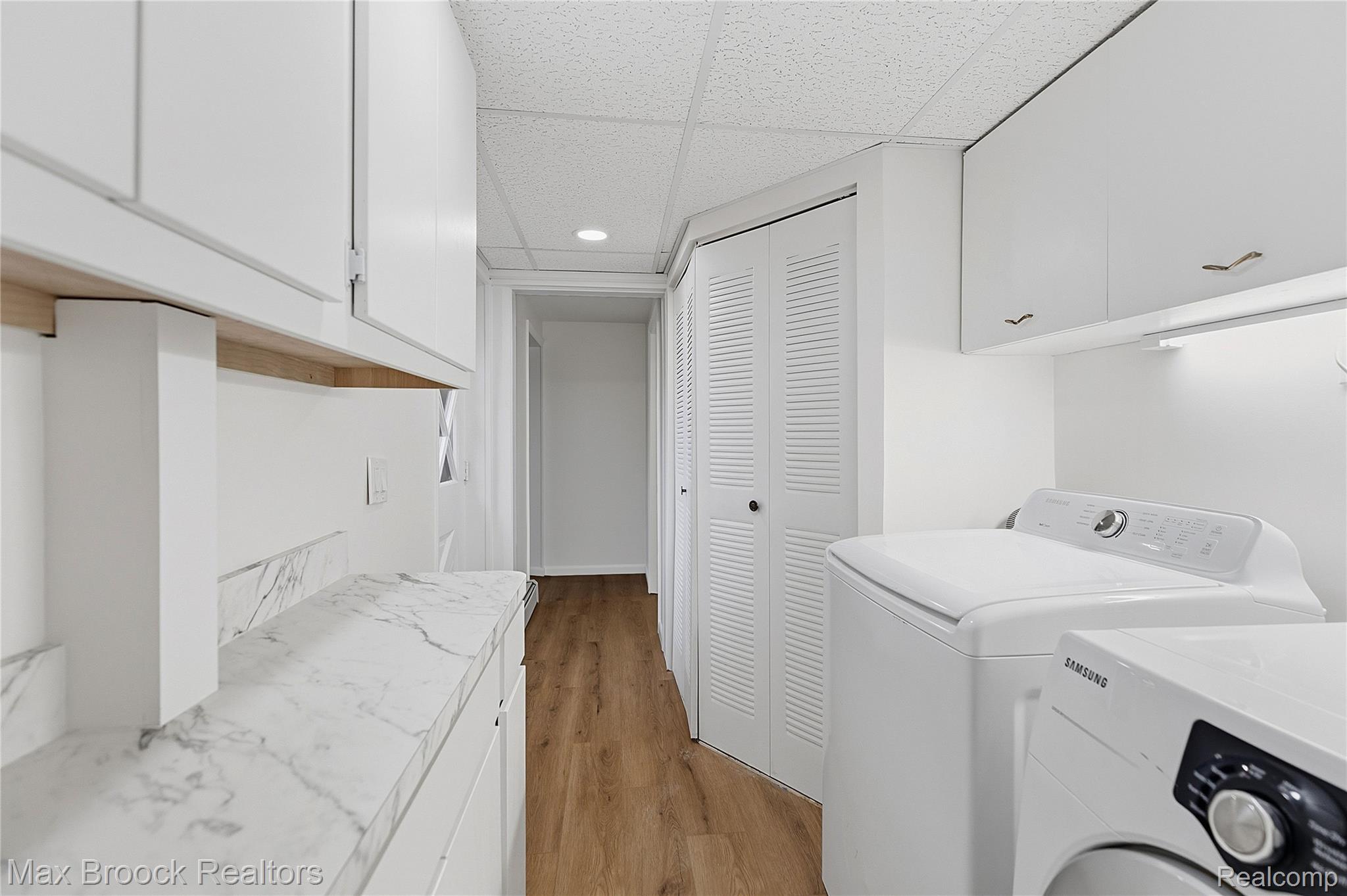 1392 Maple Grove Road Lapeer, MI 48446 - Photo 20 of 70 Laundry area featuring cabinet space, light wood-style floors, washer and clothes dryer, a paneled ceiling, and recessed lighting
