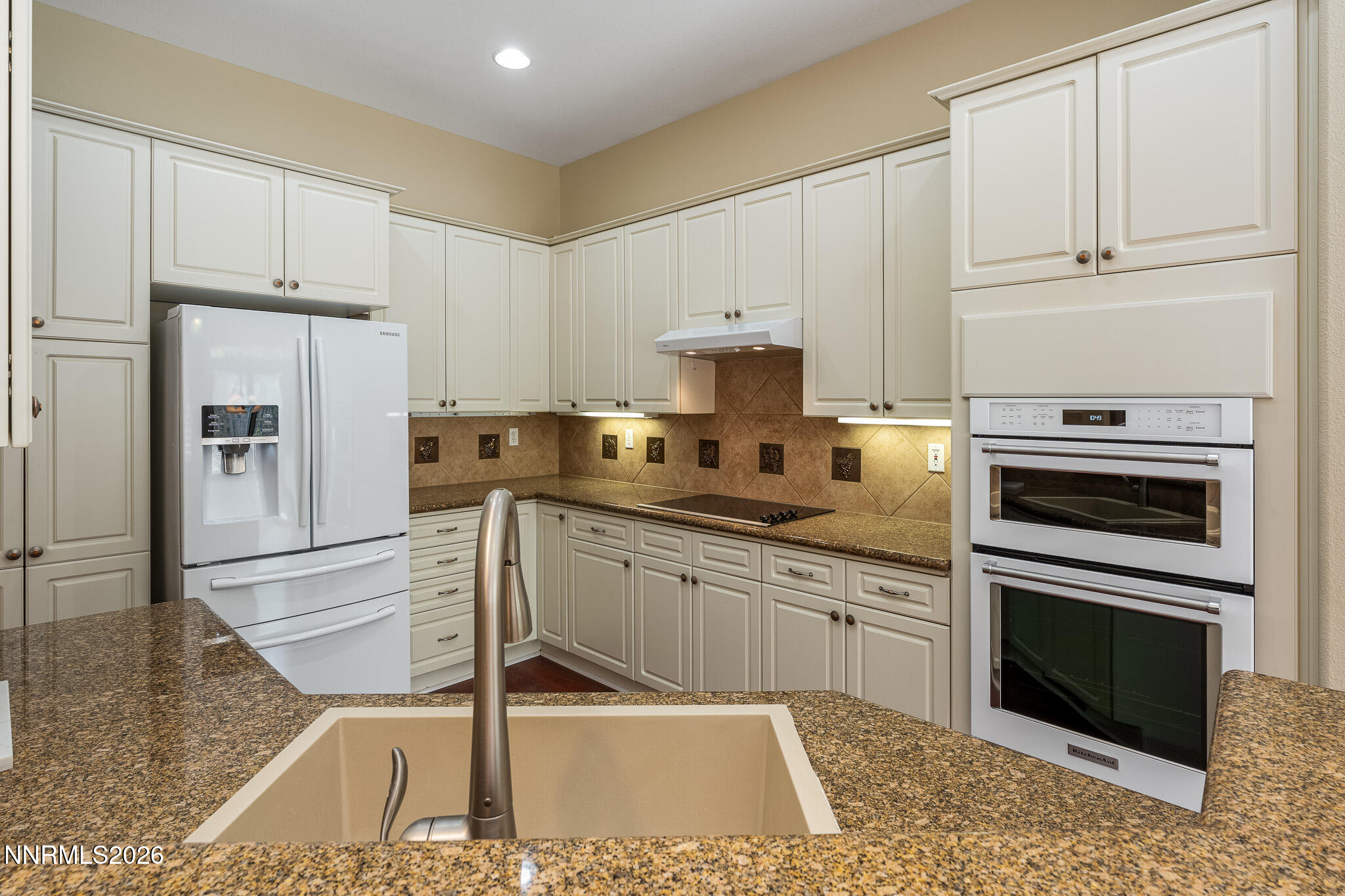 1840 Hunter Creek Road Reno, NV 89519 - Photo 7 of 39 a kitchen with kitchen island granite countertop a stove a sink and a refrigerator