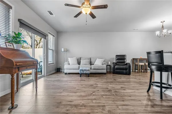 a living room with furniture and a chandelier