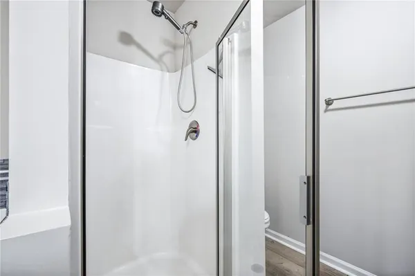 a bathroom with a glass shower door
