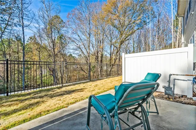 a view of chairs and bench in the balcony