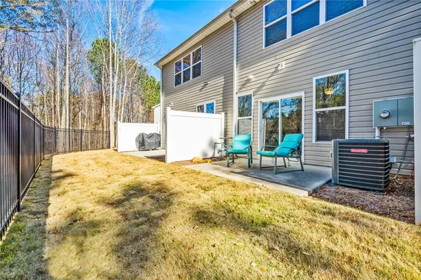 a view of a house with backyard and sitting area