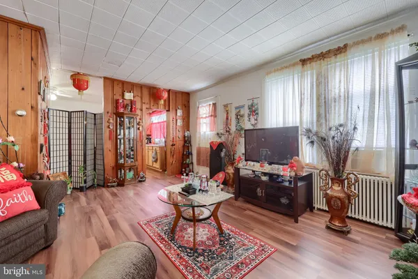 a living room with furniture a flat screen tv and a window