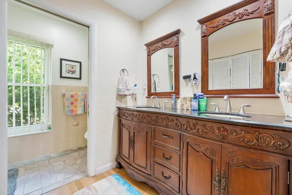 a bathroom with a sink a mirror and a shower