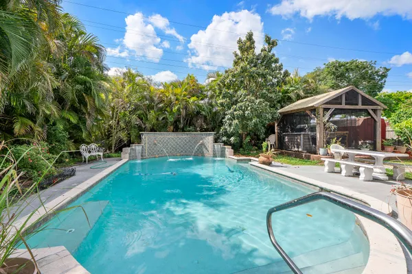 a view of a backyard with sitting area