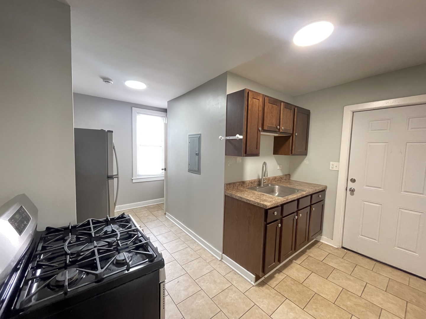 1940 West Ohio Street, Unit 1R Chicago, IL 60622 - Photo 3 of 8 a kitchen with stainless steel appliances granite countertop a stove and a refrigerator