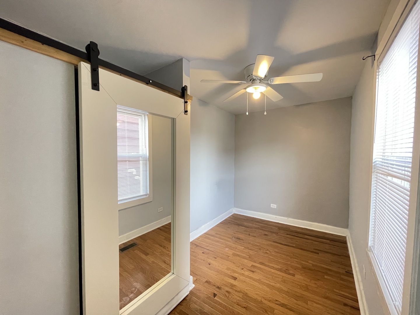 1940 West Ohio Street, Unit 1R Chicago, IL 60622 - Photo 5 of 8 a view of an empty room with wooden floor and a window
