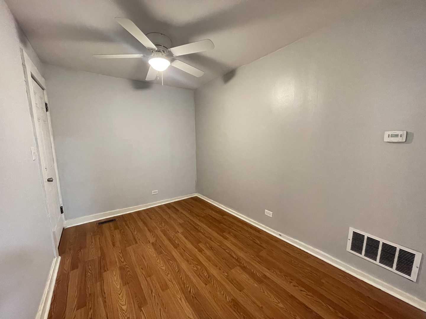 1940 West Ohio Street, Unit 1R Chicago, IL 60622 - Photo 7 of 8 a view of an empty room with wooden floor